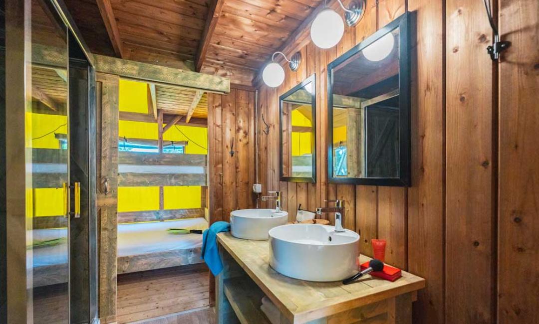 Rustikales Badezimmer mit Doppelwaschbecken und Dusche, Naturholz.