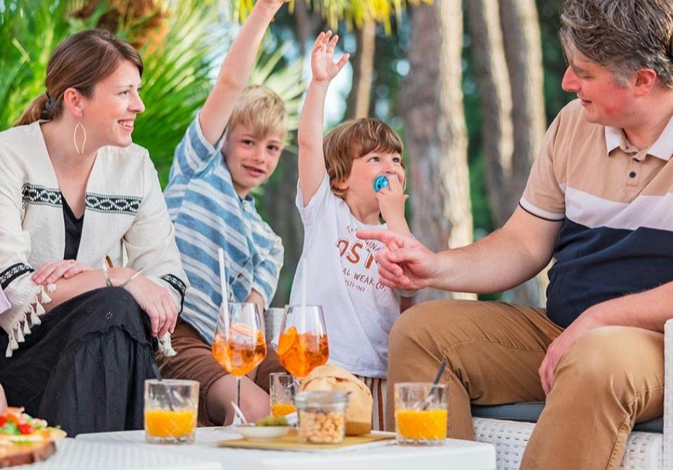 Happy family having fun outdoors with drinks and snacks.